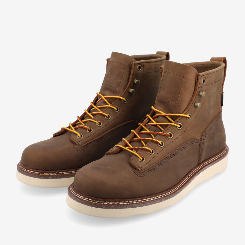 A pair of brown leather lace-up boots with yellow laces and beige rubber soles.