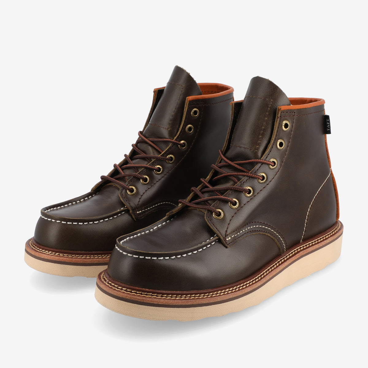 A pair of dark brown leather lace-up boots with cream-colored soles, white stitching, and metal eyelets.