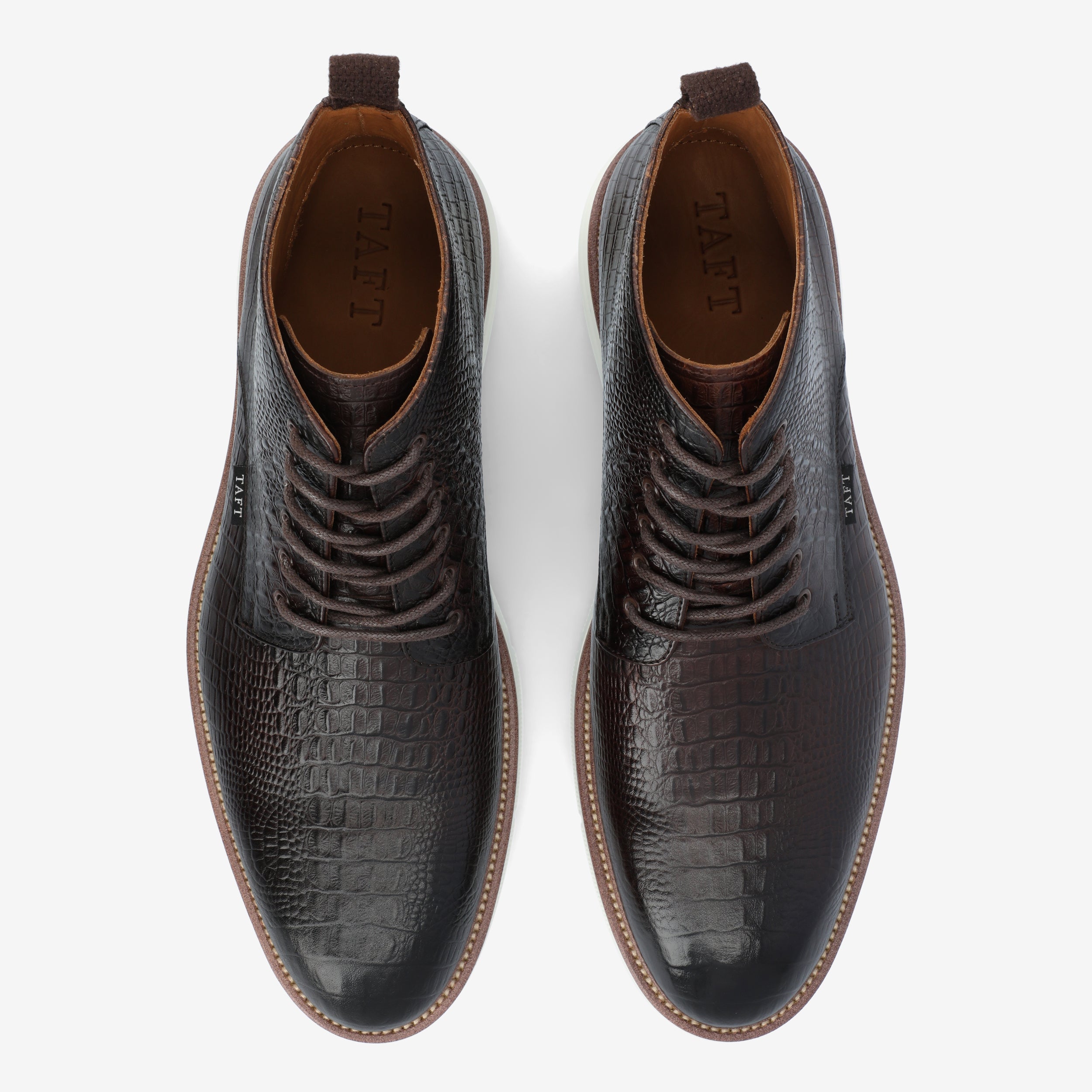 A pair of dark brown, crocodile-patterned leather dress shoes with white soles, viewed from above.