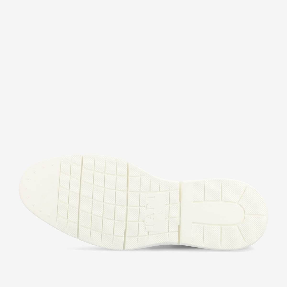 The image shows the bottom view of a white shoe sole with a grid-like traction pattern and the word TAFT embossed in the center.