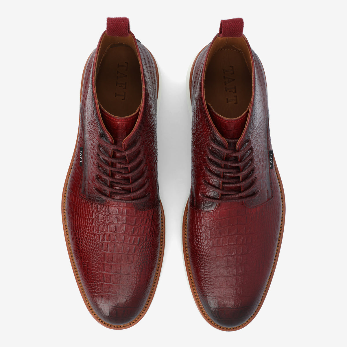 Top view of a pair of textured red leather dress shoes with brown soles, labeled TAFT on the insole.