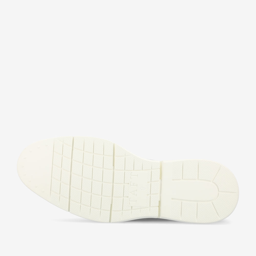 The image shows the sole of a shoe with a grid-like pattern and the word TAFT embossed on it. The sole is white with a slightly grooved texture.