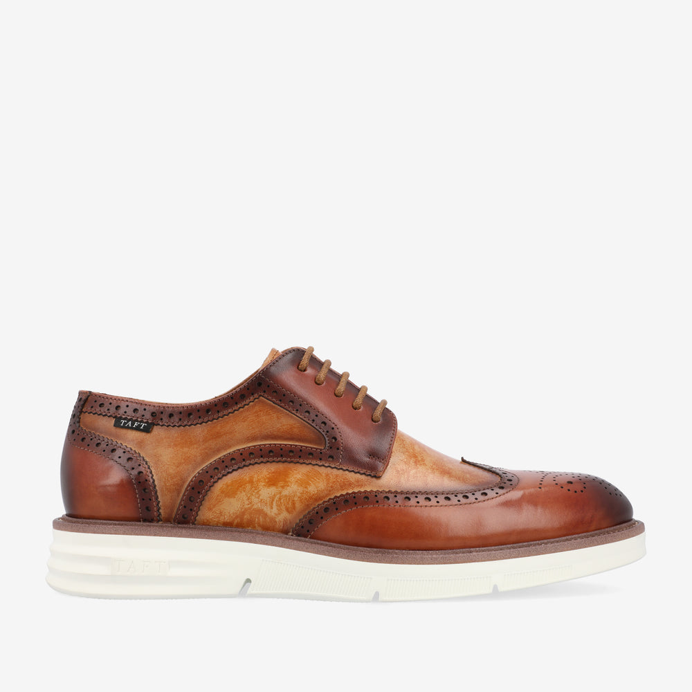 A brown and light tan wingtip brogue shoe with white sole, featuring decorative perforations and lacing.