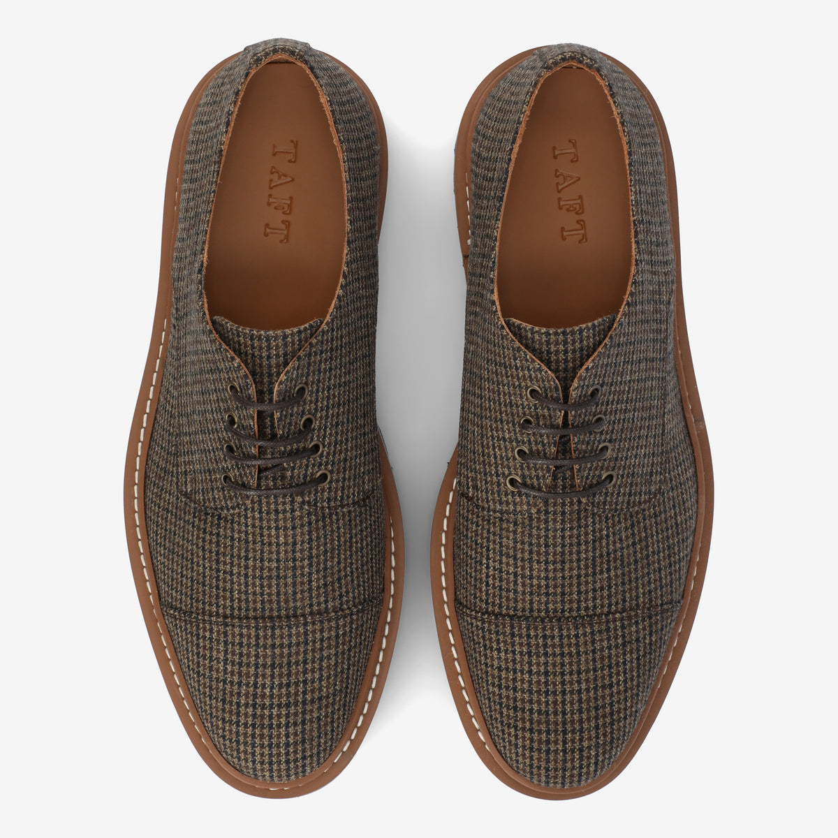 Brown and gray houndstooth patterned lace-up shoes with brown soles, viewed from above.