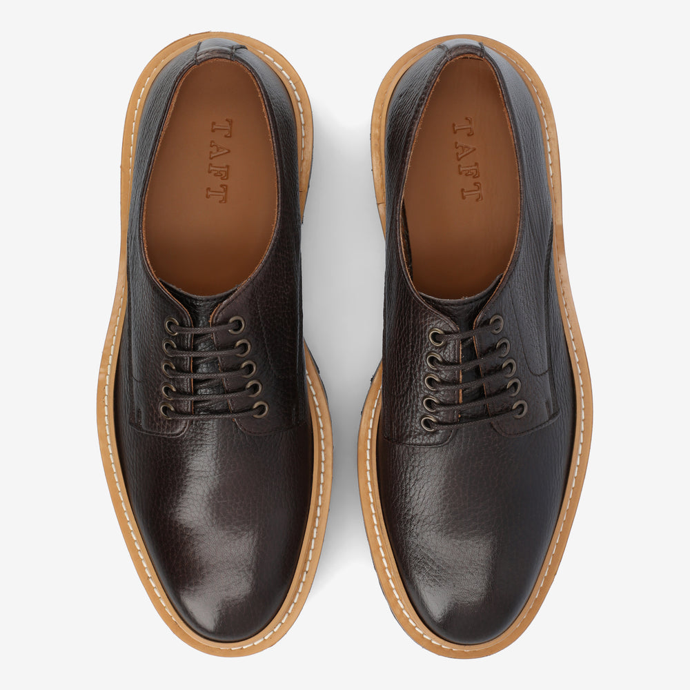 A pair of dark brown leather lace-up shoes with tan rubber soles viewed from above, showing the brand name TAFT on the insole.