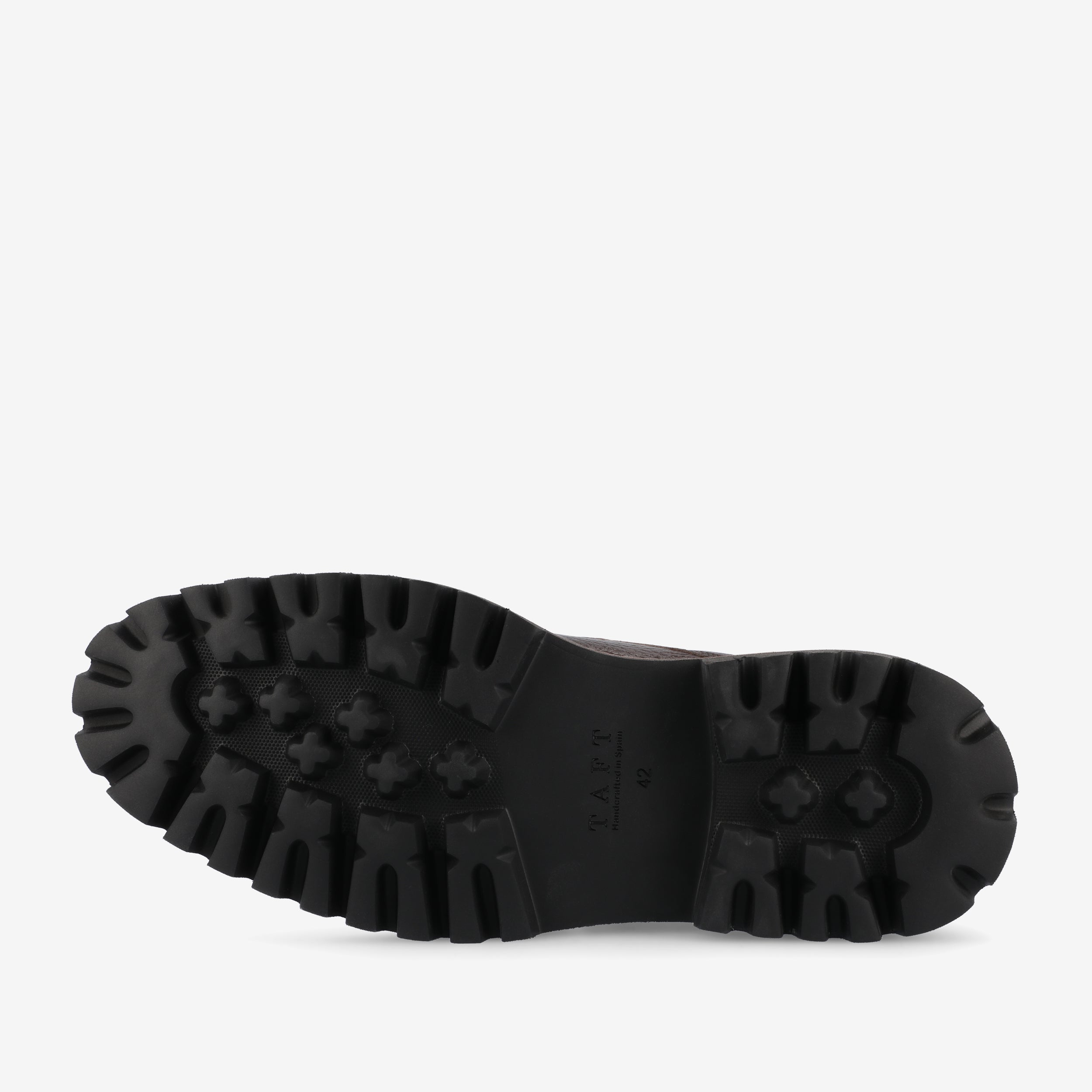 The image shows the black rubber sole of a shoe with a rugged tread pattern.