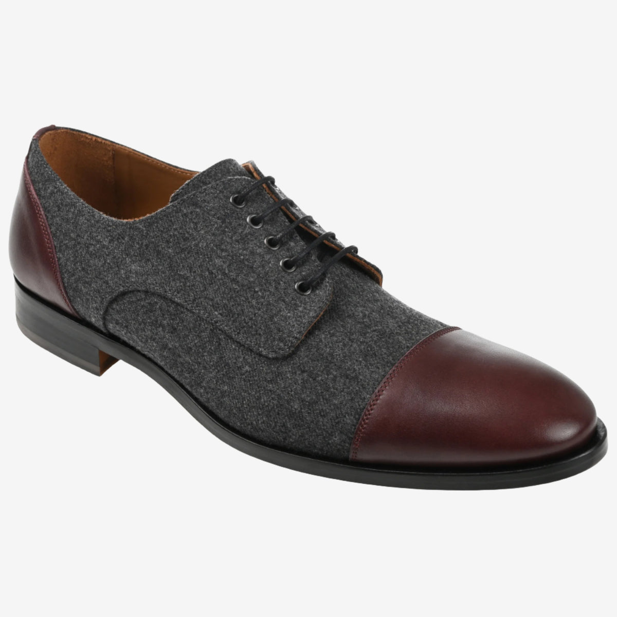 A men's lace-up dress shoe with a woolen grey body, dark brown leather cap toe, quarters, and heel, featuring a black sole.