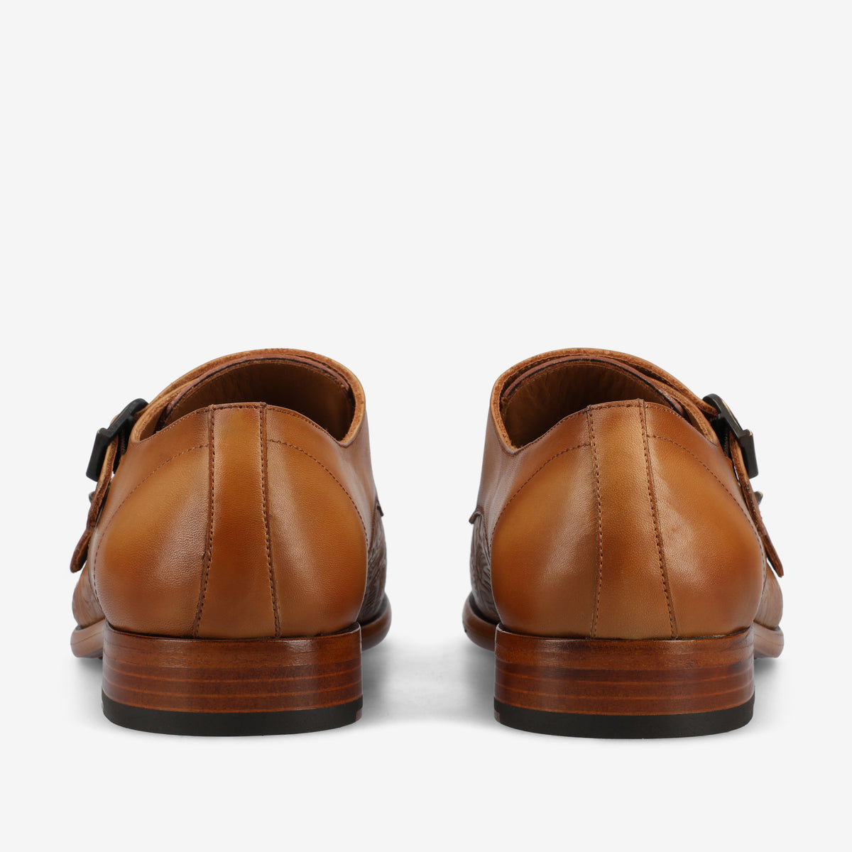 A rear view of a pair of tan leather dress shoes with brown wooden soles, featuring a double buckle design.