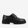 A black lace-up shoe with a textured woven design on the sides, a smooth toe cap, and a thick, rugged sole.