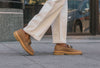 The Verona Loafers on feet, walking down a sidewalk. 