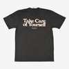 A black T-shirt with the printed text Take Care of Yourself in large pink letters and the brand name TAFT underneath.