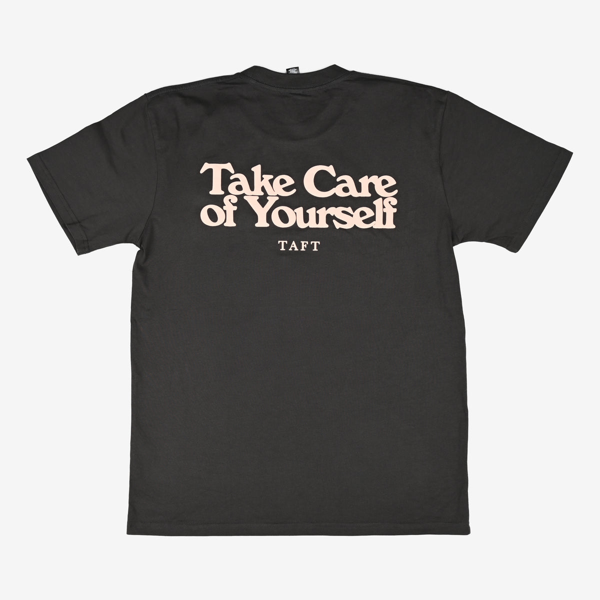 A black T-shirt with the printed text Take Care of Yourself in large pink letters and the brand name TAFT underneath.