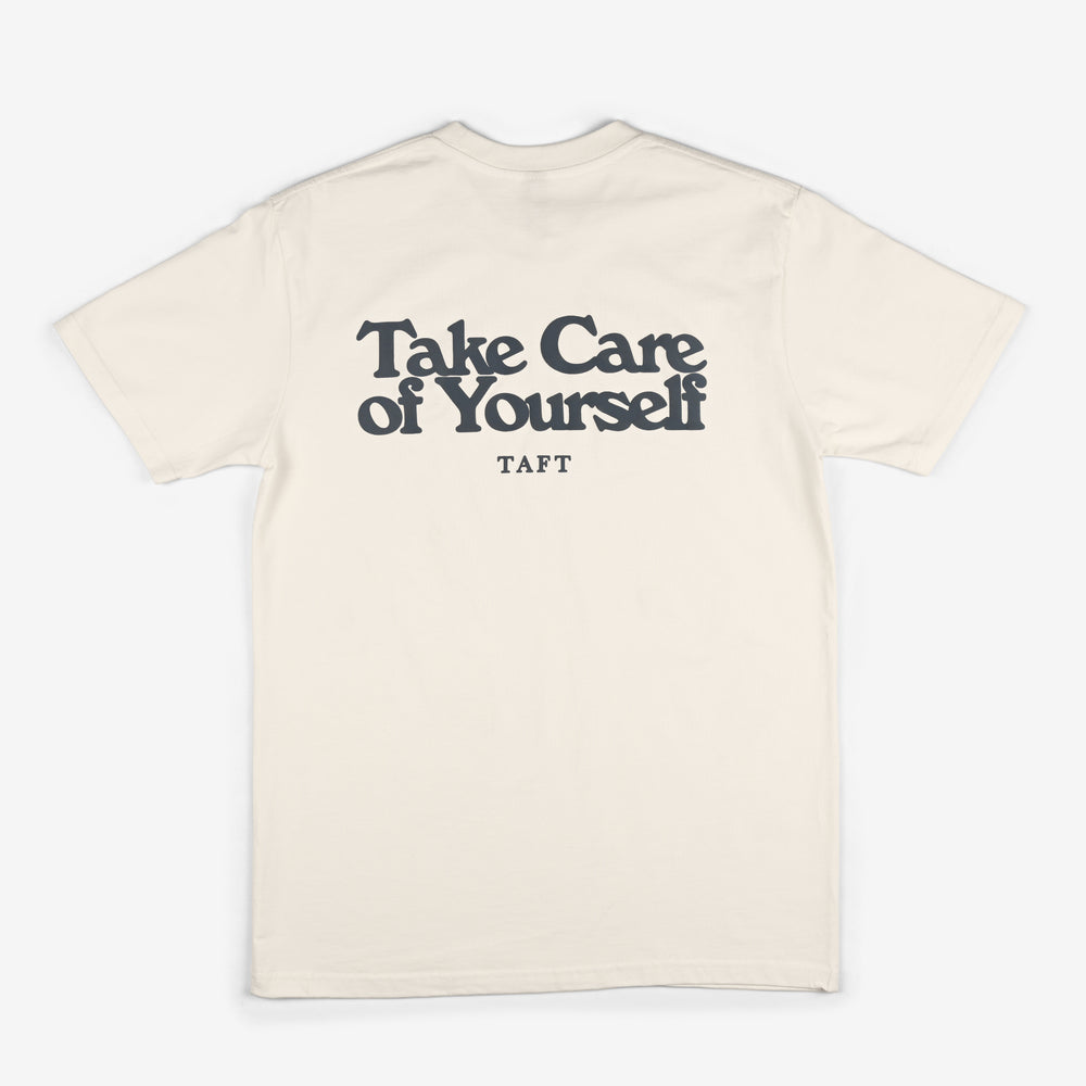 A white t-shirt with the text Take Care of Yourself and TAFT printed in black on the back.