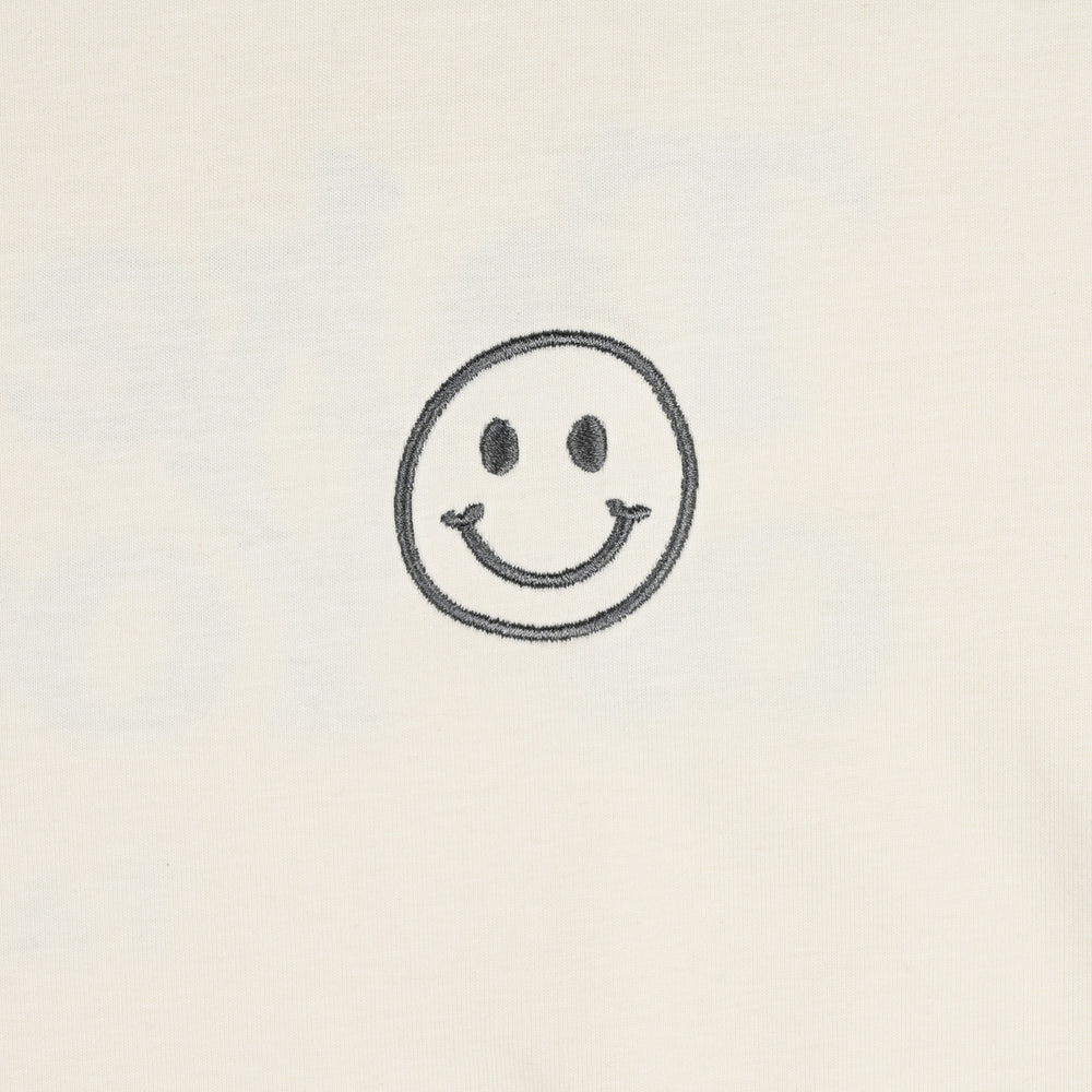 A simple black smiley face drawing on a plain beige background.