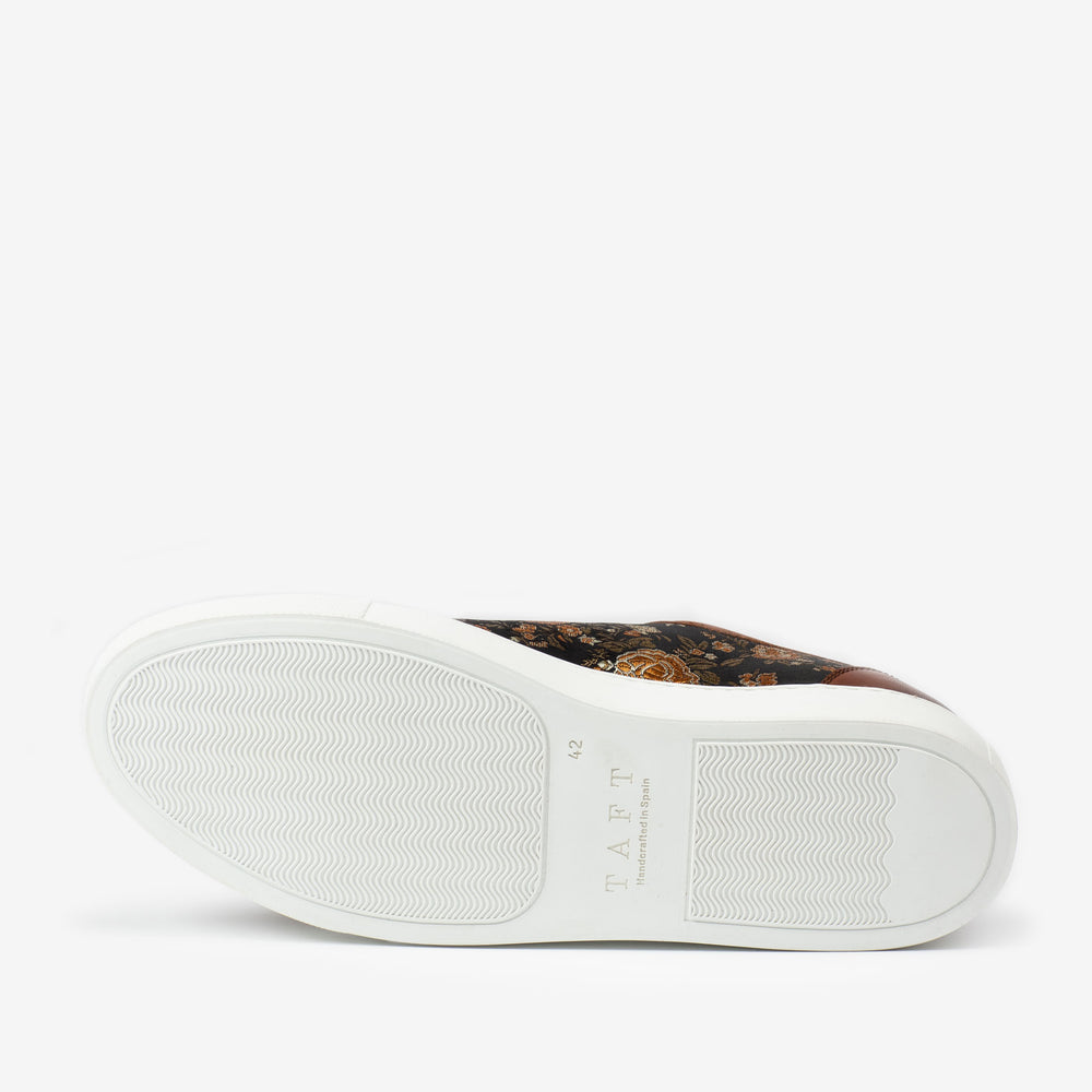 Image of the sole of a shoe with a white rubber outsole, showing tread pattern and the brand name TAFT. The upper part features a floral design.