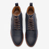 A pair of navy blue leather lace-up boots with brown accents and tan insides, viewed from above.