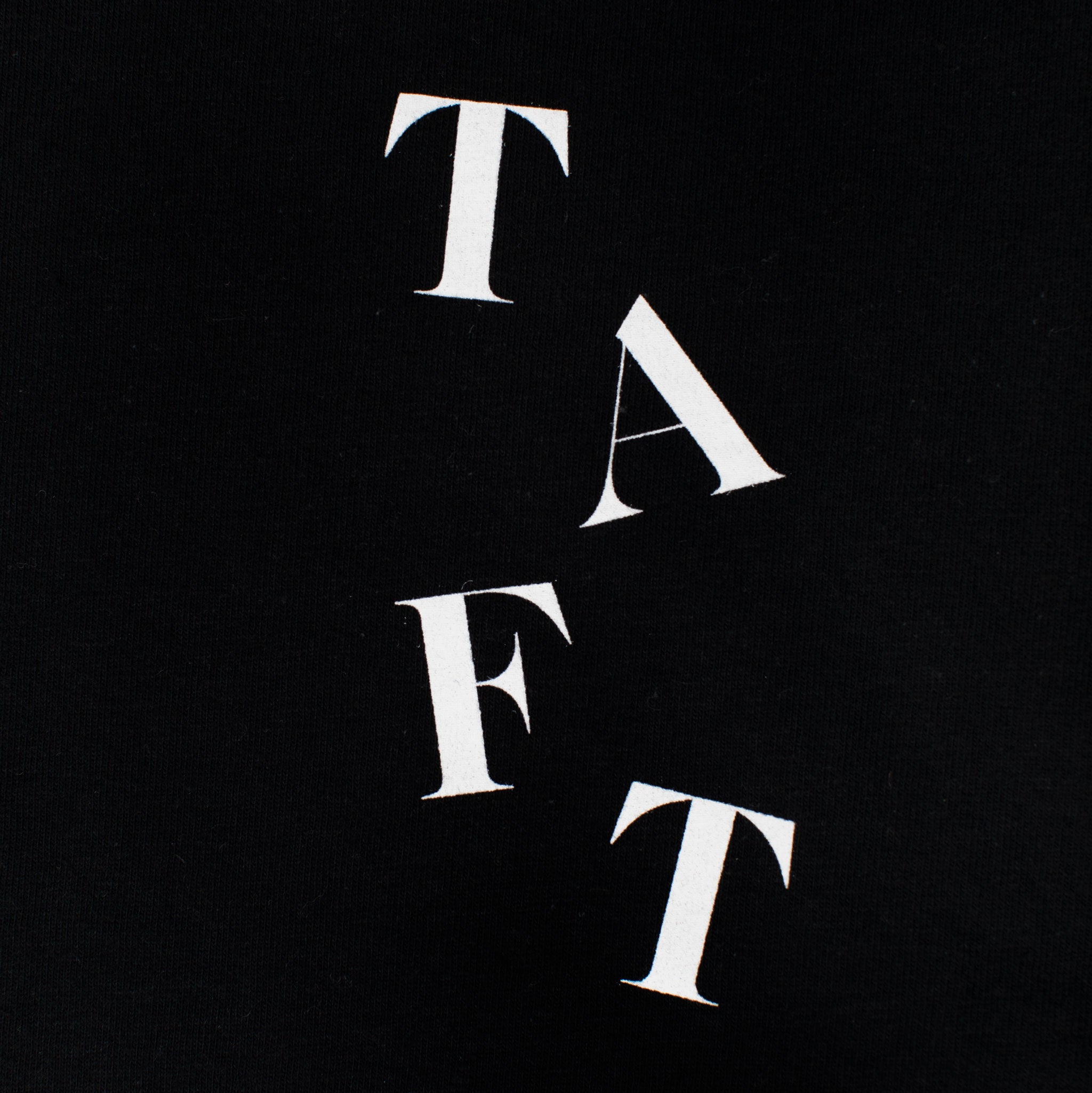 Black background with white letters arranged diagonally spelling TAFT.