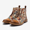 A pair of ankle-high boots with brown leather toe caps and heels, featuring a colorful floral tapestry fabric on the sides.