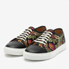 A pair of black leather sneakers with a white sole and laces, featuring a colorful floral pattern on the sides.