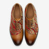 A pair of men's dress shoes featuring intricate red and gold paisley patterns on the sides and smooth brown leather on the toes and laces, viewed from above.