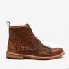 A brown, woven leather boot with a tan sole and lace-up front against a white background.