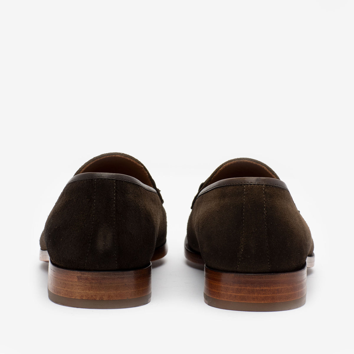 Rear view of a pair of brown suede loafers with wooden soles, placed against a white background.