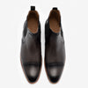 A pair of black leather dress shoes with brown trim, viewed from above on a white background.