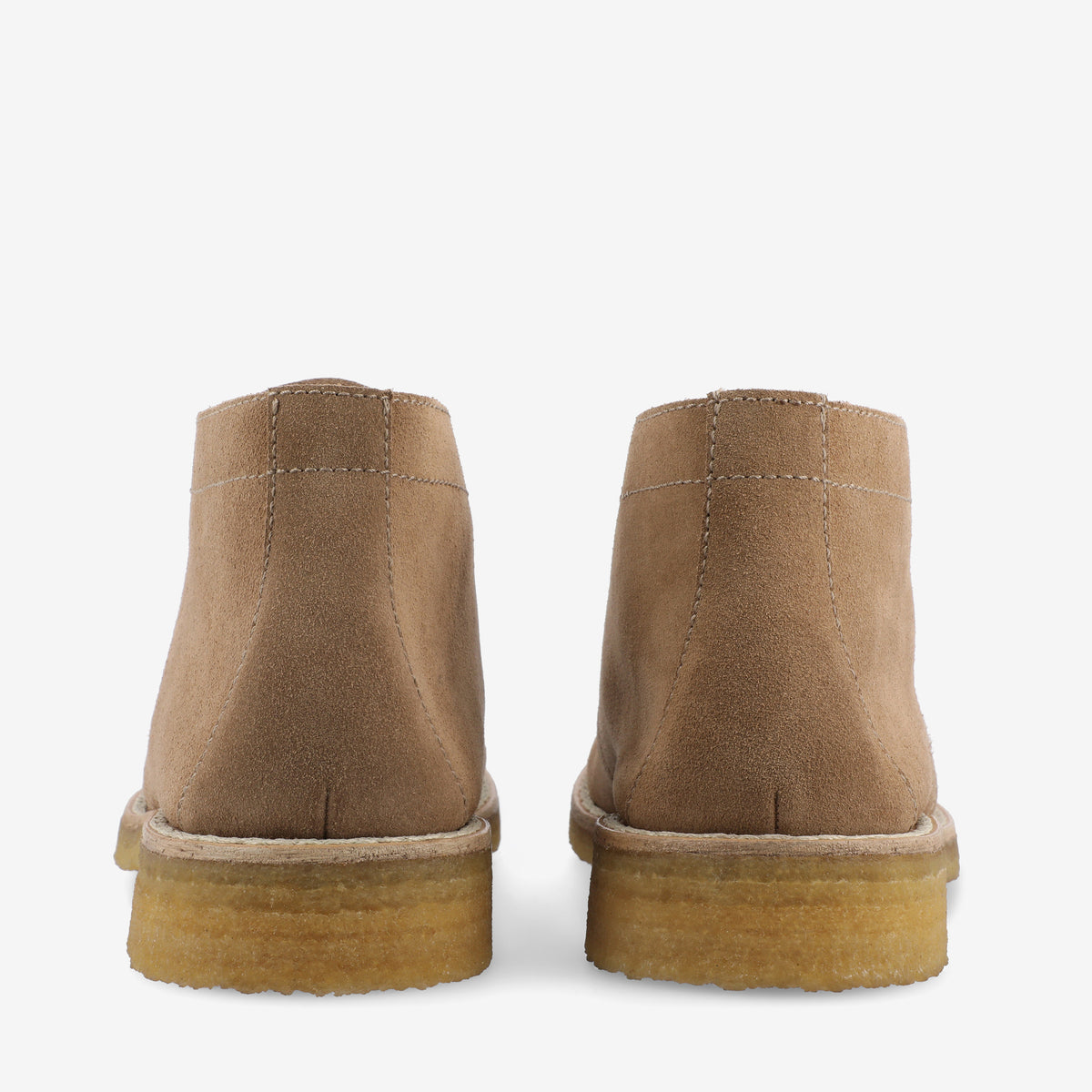 Rear view of a pair of tan suede ankle boots with cream rubber soles on a white background.