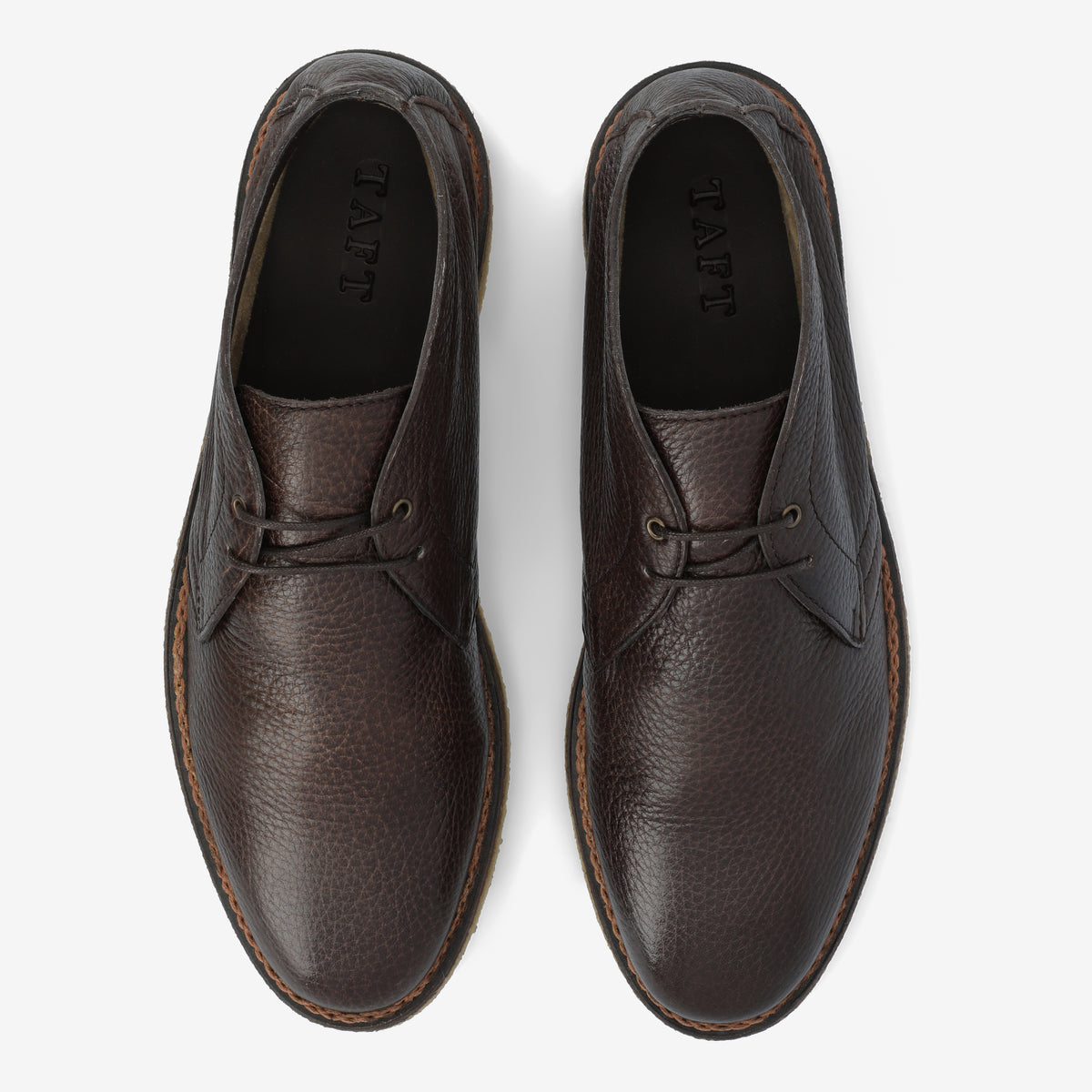 A pair of brown leather dress shoes viewed from above, with TAFT inscribed on the insoles. The shoes have laces and visible stitching along the soles.