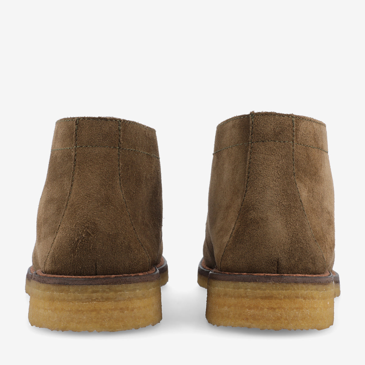 Rear view of a pair of brown suede ankle boots with rubber soles on a white background.