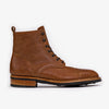 A single brown leather lace-up boot with black eyelets and a loop at the back, featuring a low heel and textured sole.