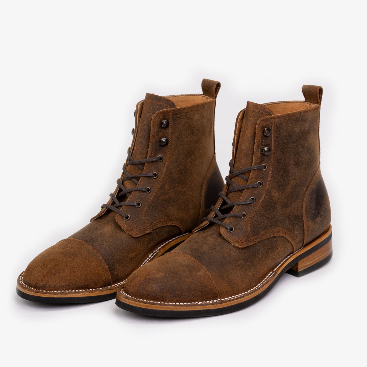 A pair of brown leather lace-up boots with a rugged, worn texture and a light tan inner lining, displayed on a plain white background.