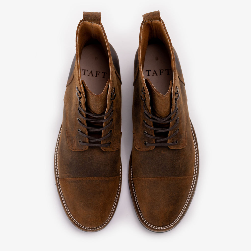 A pair of brown leather lace-up boots with TAFT branding inside, photographed from above on a white background.