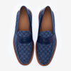 Top view of a pair of blue patterned loafers with brown soles, featuring a leather detail across the front.