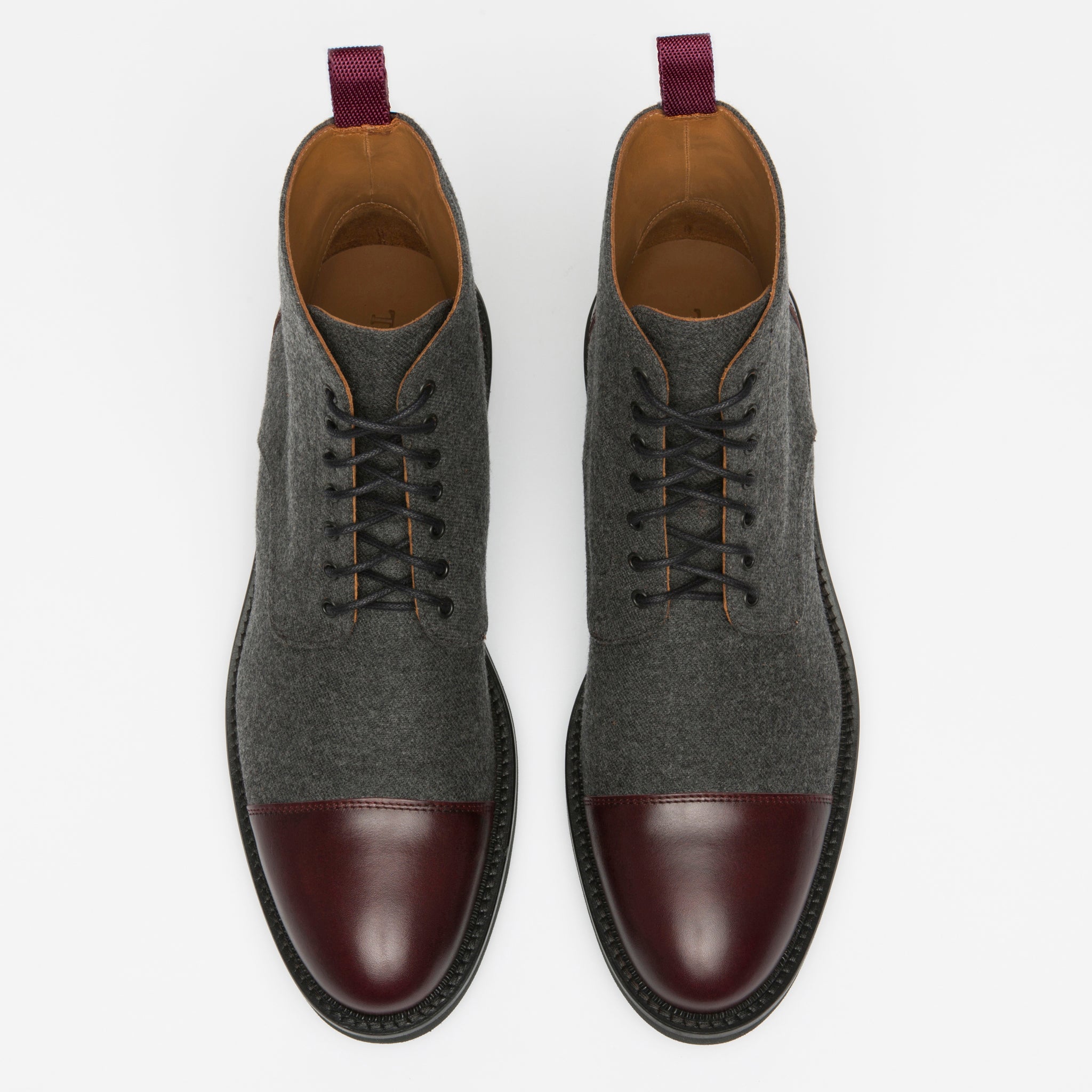 A pair of men's dress boots with dark grey fabric and burgundy leather cap-toes, featuring black laces and purple pull tabs on the heels, displayed on a white background.