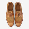 A pair of tan and brown leather brogue shoes with laces, viewed from above on a white background.