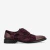 Maroon velvet and leather lace-up dress shoe with a cap toe and black sole, viewed from the side.