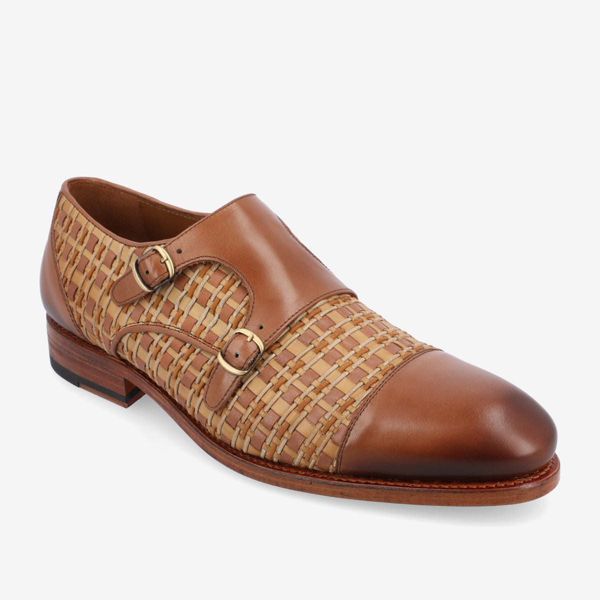 A brown leather shoe with woven detailing and two buckles on the side, featuring a low heel and smooth toe cap.