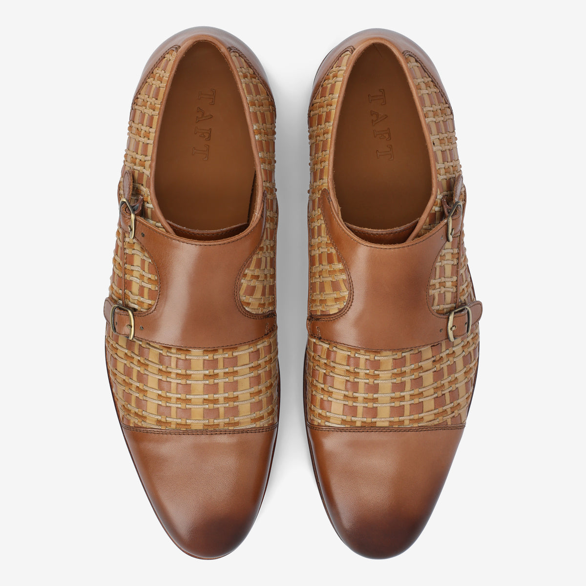 Pair of brown leather shoes with woven patterns on the sides and buckle closures, viewed from above.