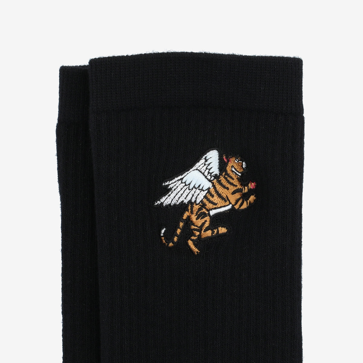 A pair of black socks featuring an embroidered design of a flying tiger with white wings.