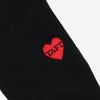 Close-up of a black fabric with a red embroidered heart featuring the word TAFT in the center.