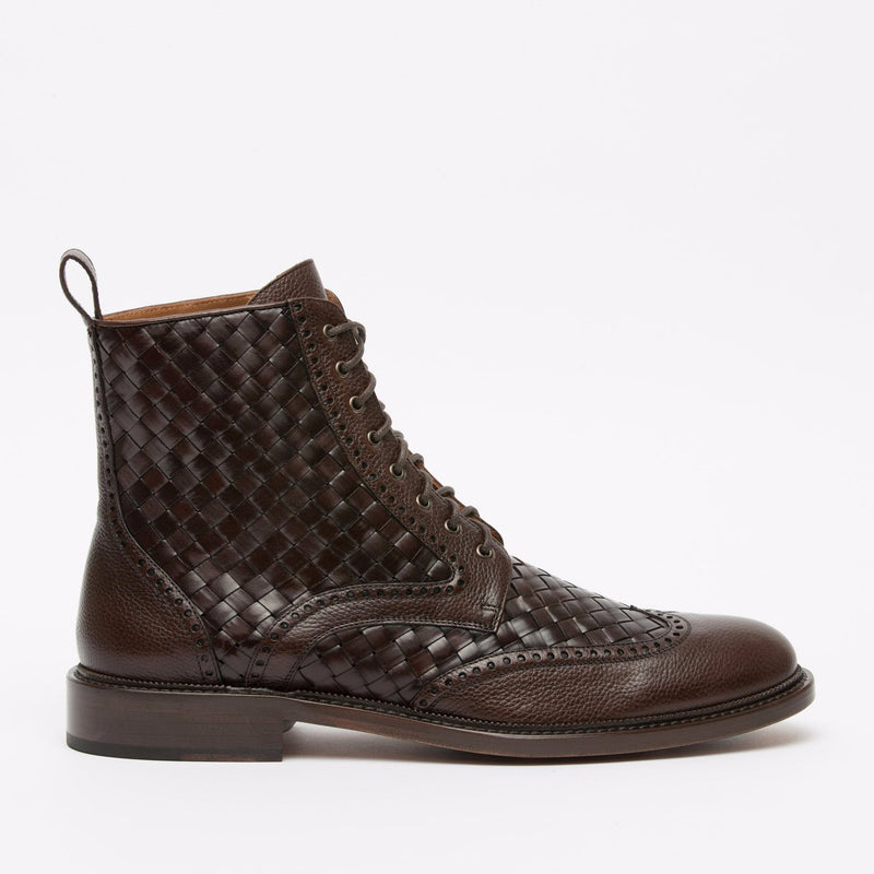 A brown leather lace-up boot with a woven texture on the sides and brogue detailing on the toe and upper sections.