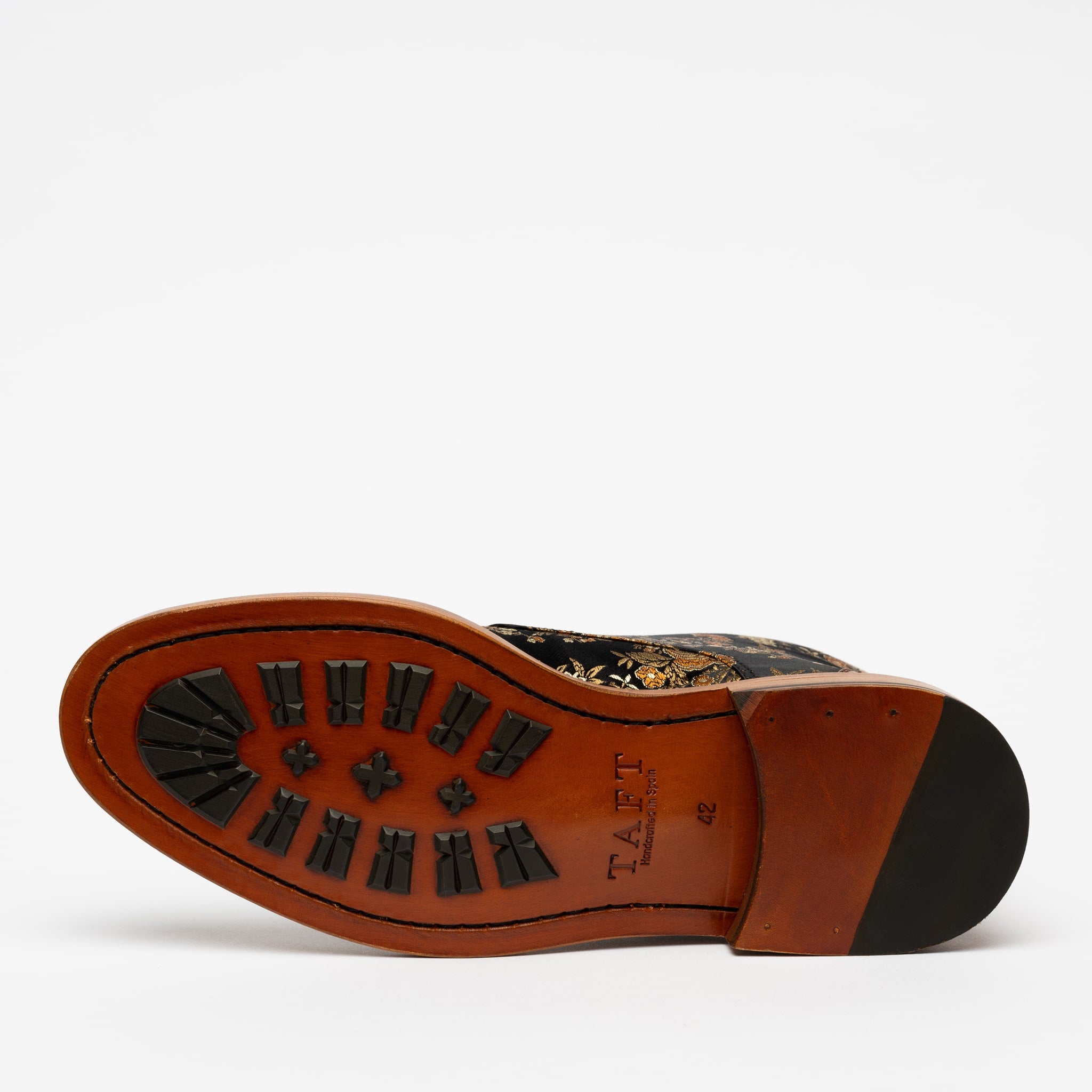 The sole of a shoe, featuring a brown and black color scheme with various textured patterns, and the branding TAFT stamped on it.