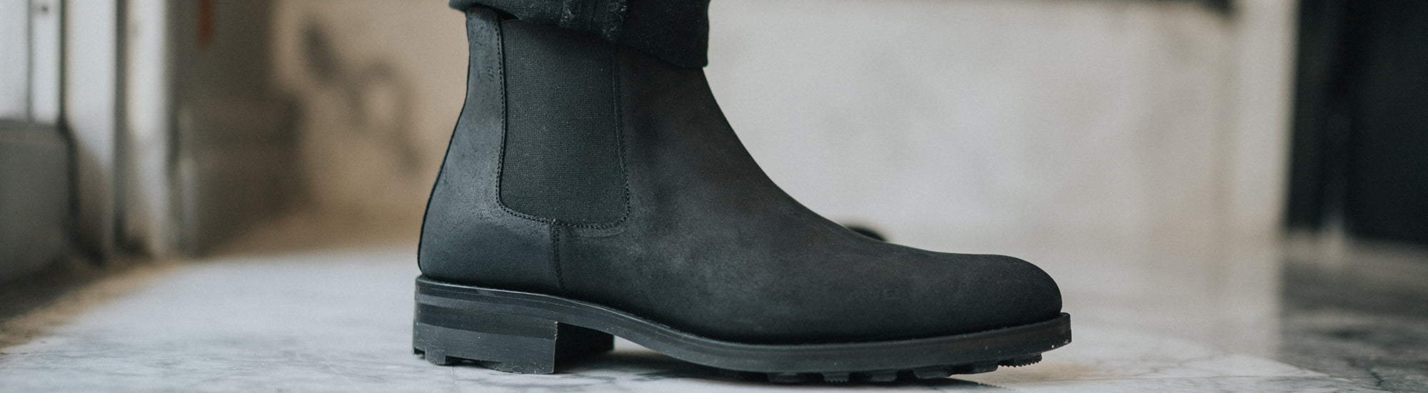 The Drake Boot in Midnight on model, up close side view {{content,hide}}