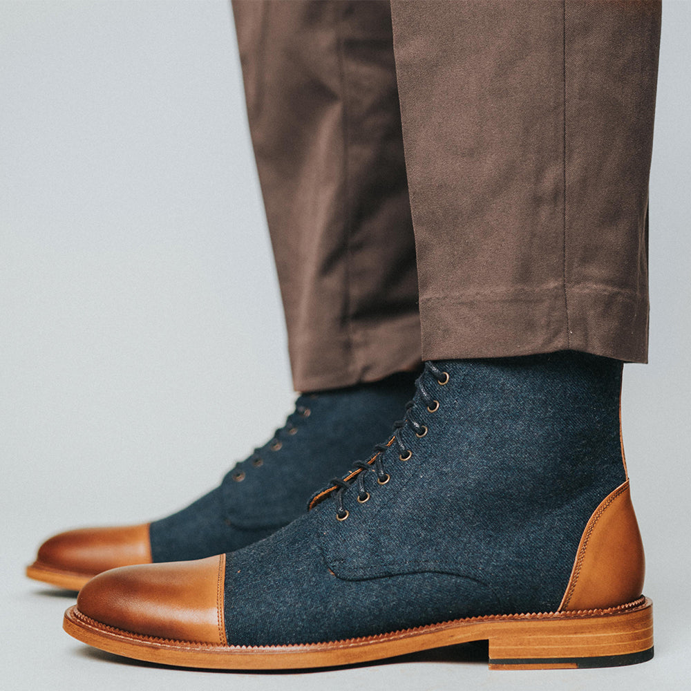 The Jack Boot in Navy on model wearing brown slacks {{featured-B}}